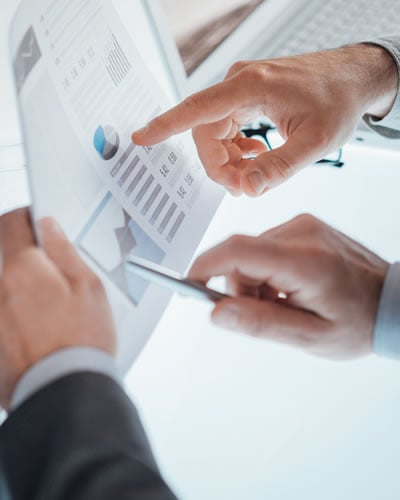 Business Financial Planning - Two people looking over the business plans