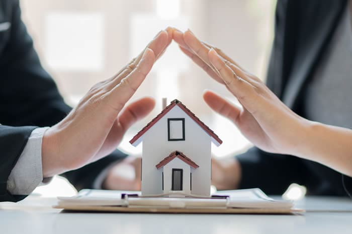 Mortgage Protection Insurance - Couple covering house